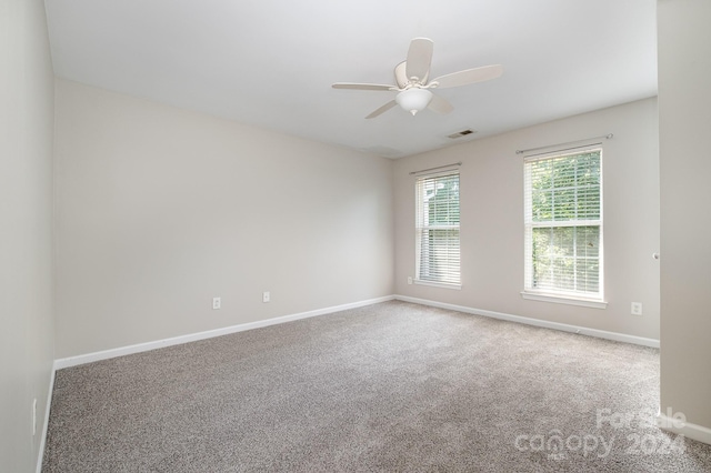 spare room with ceiling fan and carpet flooring