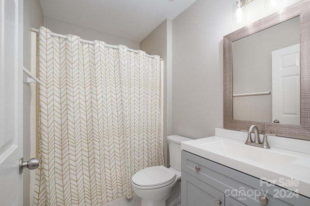 bathroom featuring vanity, toilet, and a shower with curtain