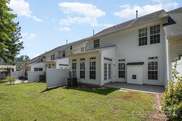 back of house with a patio area, a yard, and central air condition unit