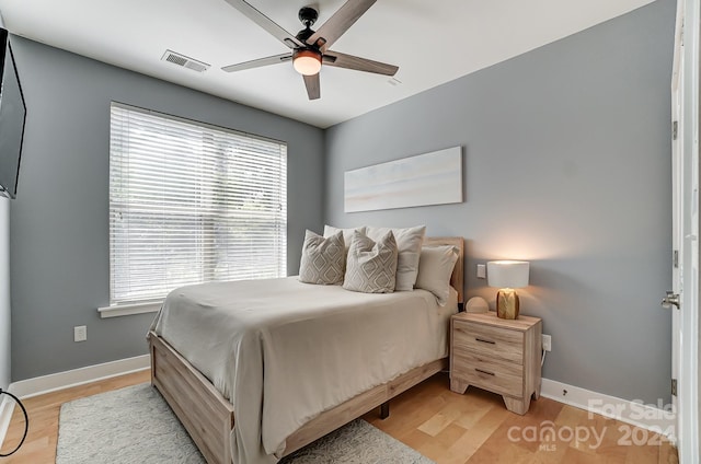 bedroom with light hardwood / wood-style flooring and ceiling fan