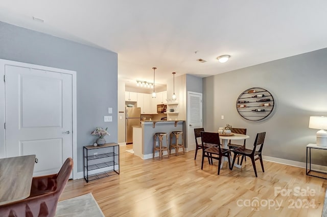 dining area with light hardwood / wood-style floors