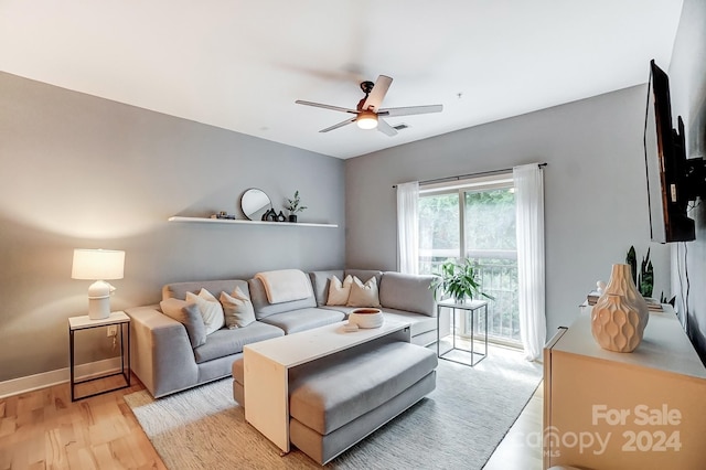 living room featuring ceiling fan and light wood-type flooring