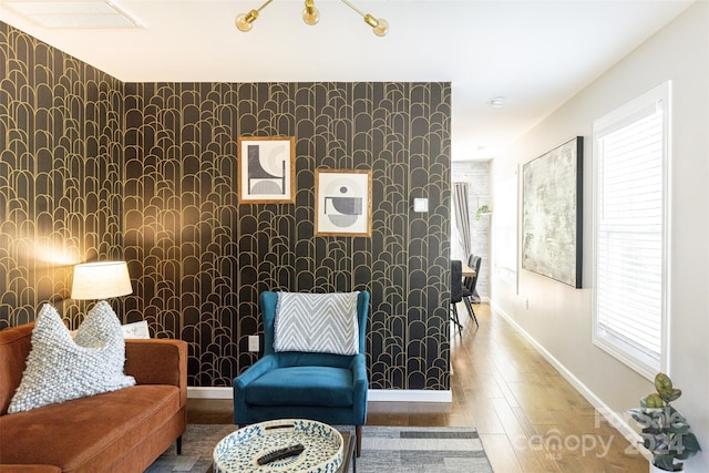 sitting room with plenty of natural light and wood-type flooring