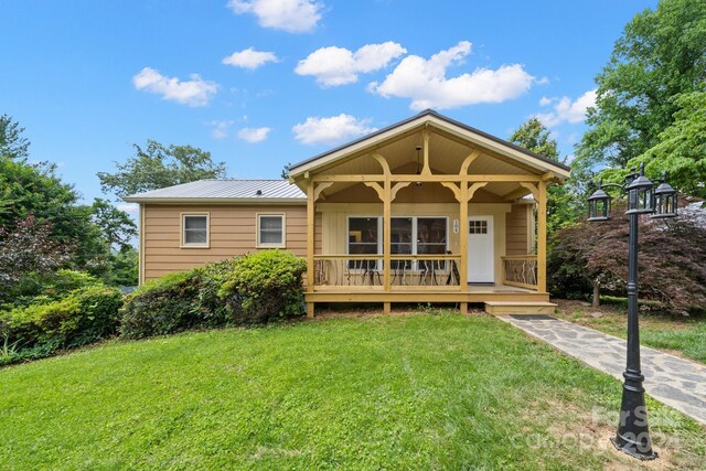 bungalow-style home with a front lawn