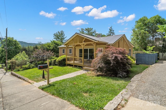 view of front of home featuring covered porch and a front yard