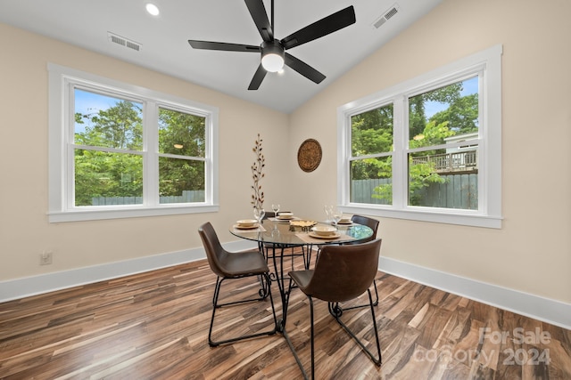 dining room featuring lofted ceiling, a healthy amount of sunlight, wood-type flooring, and ceiling fan