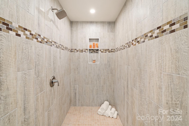 bathroom with a tile shower