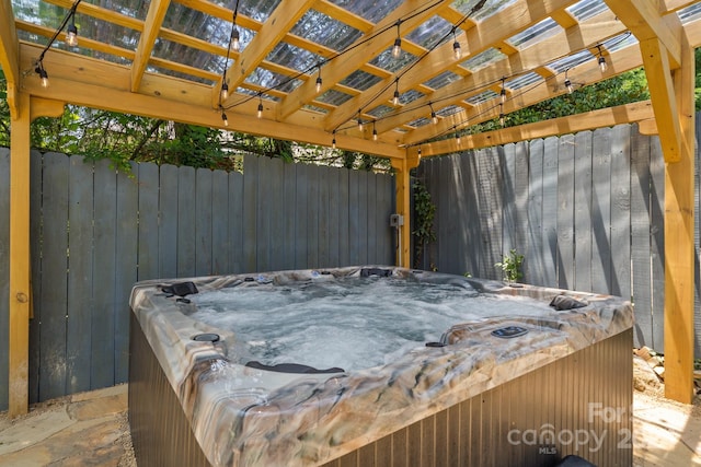 view of patio / terrace with a hot tub