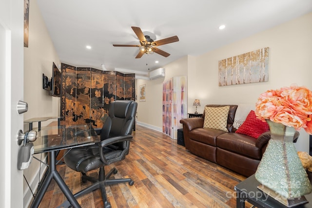 office space featuring ceiling fan, hardwood / wood-style flooring, and an AC wall unit