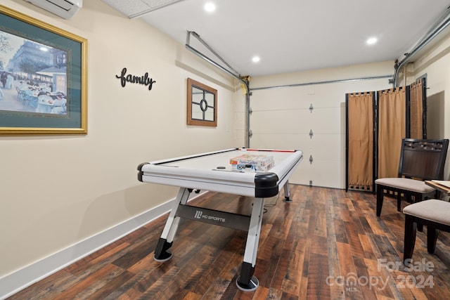 playroom featuring a wall unit AC and dark hardwood / wood-style flooring