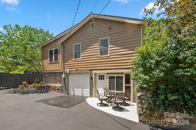 rear view of house featuring a garage