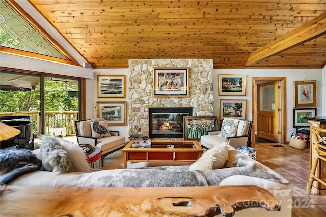 living area with a stone fireplace, tile patterned flooring, lofted ceiling with beams, and wood ceiling