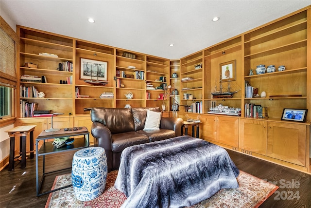 sitting room featuring dark wood-type flooring, built in features, and recessed lighting
