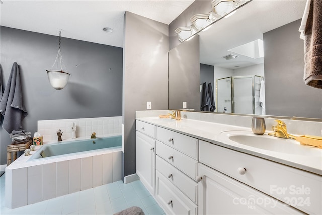 full bath featuring a sink, a shower stall, double vanity, and a garden tub