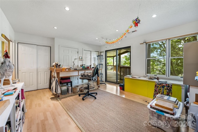 office with recessed lighting, visible vents, a textured ceiling, and wood finished floors