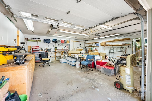 garage featuring a garage door opener and a workshop area