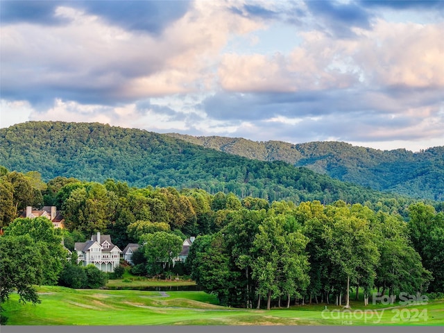view of mountain feature with a view of trees and view of golf course