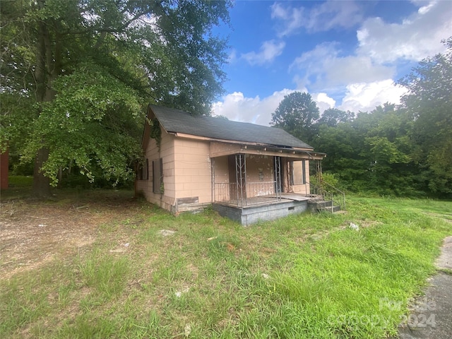 exterior space with concrete block siding and covered porch