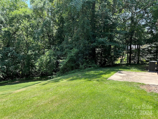 view of yard featuring a patio area and central air condition unit