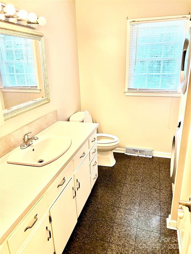 bathroom featuring toilet and vanity