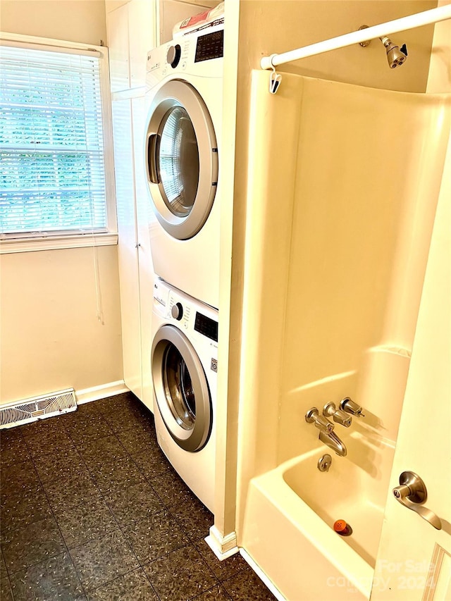 laundry room with stacked washer / dryer