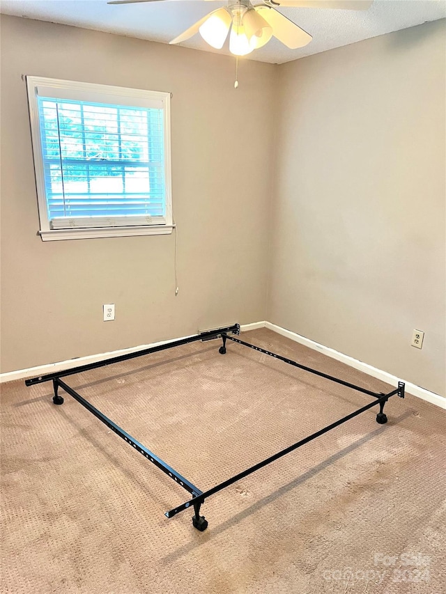 carpeted empty room with ceiling fan