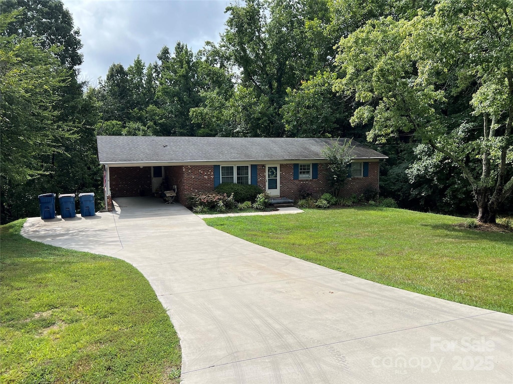 1111 S Skyland Dr, Mount Pleasant, NC 28124 - ranch-style house featuring driveway, a front yard, an attached carport, and brick siding