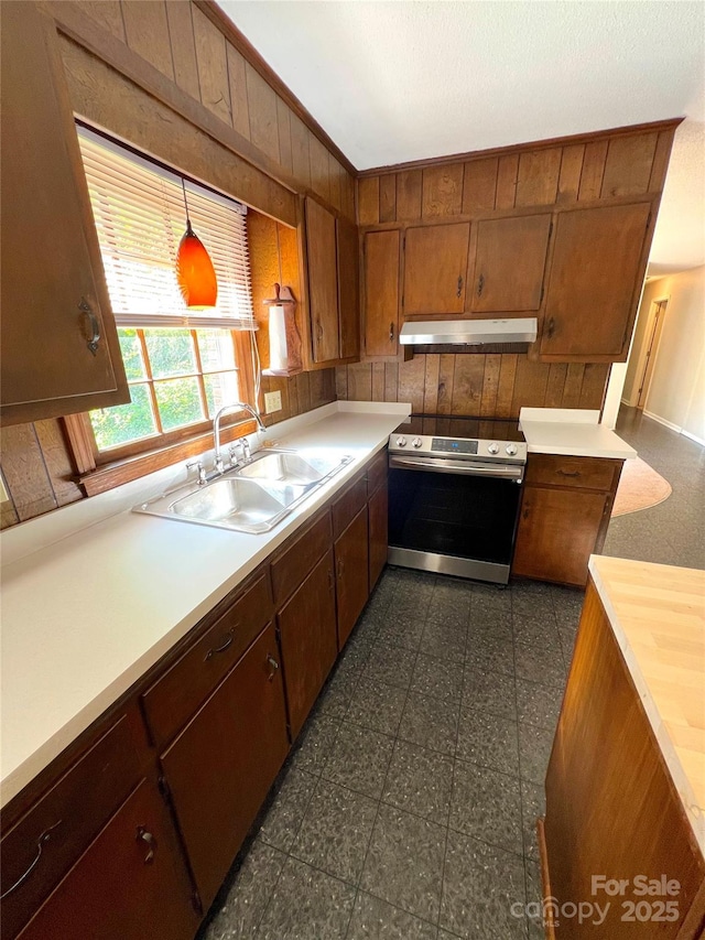 1111 S Skyland Dr, Mount Pleasant, NC 28124 - kitchen featuring a sink, under cabinet range hood, wooden walls, brown cabinetry, and electric range