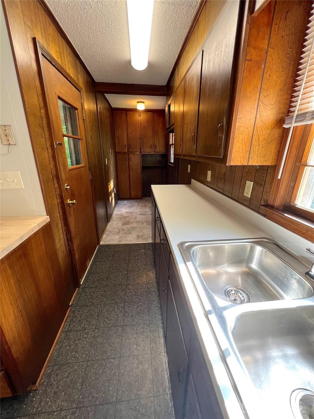 1111 S Skyland Dr, Mount Pleasant, NC 28124 - kitchen featuring a textured ceiling, wooden walls, and light countertops