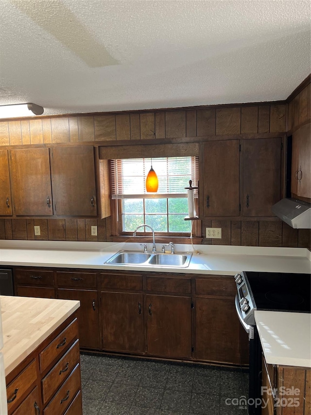 1111 S Skyland Dr, Mount Pleasant, NC 28124 - kitchen featuring stainless steel range with electric cooktop, a textured ceiling, under cabinet range hood, a sink, and wood counters