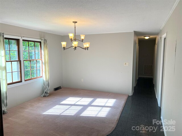 1111 S Skyland Dr, Mount Pleasant, NC 28124 - unfurnished room with a chandelier, a textured ceiling, ornamental molding, and visible vents
