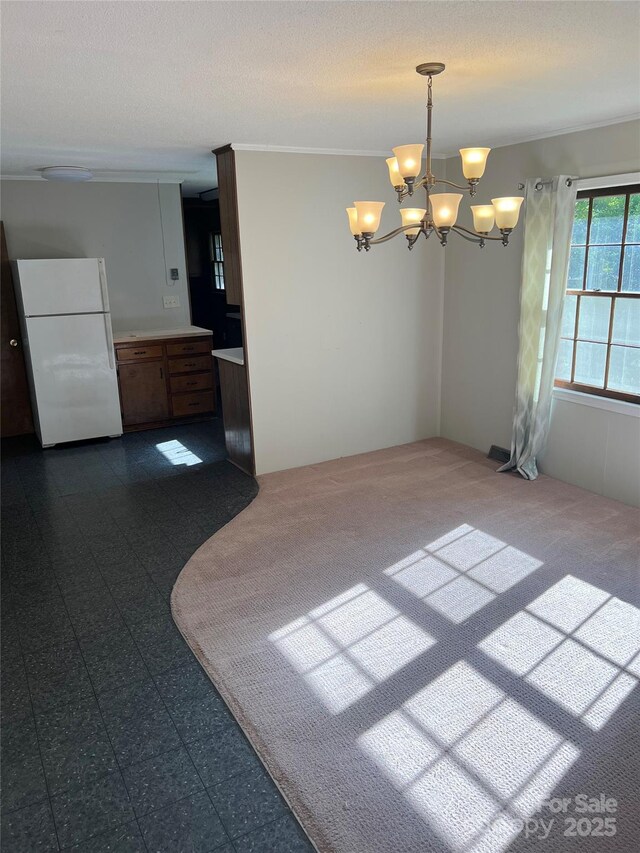 1111 S Skyland Dr, Mount Pleasant, NC 28124 - unfurnished dining area featuring dark carpet, ornamental molding, and a notable chandelier