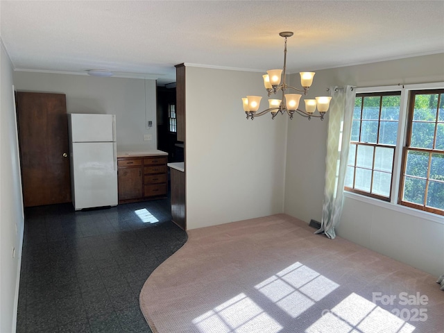 1111 S Skyland Dr, Mount Pleasant, NC 28124 - unfurnished dining area featuring a notable chandelier, ornamental molding, and dark colored carpet