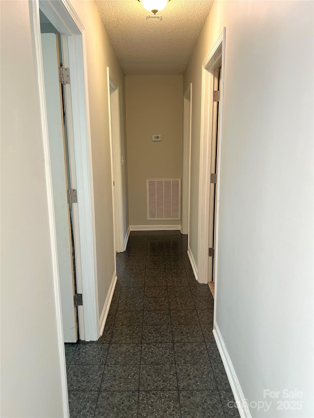 1111 S Skyland Dr, Mount Pleasant, NC 28124 - hall with visible vents, baseboards, and a textured ceiling