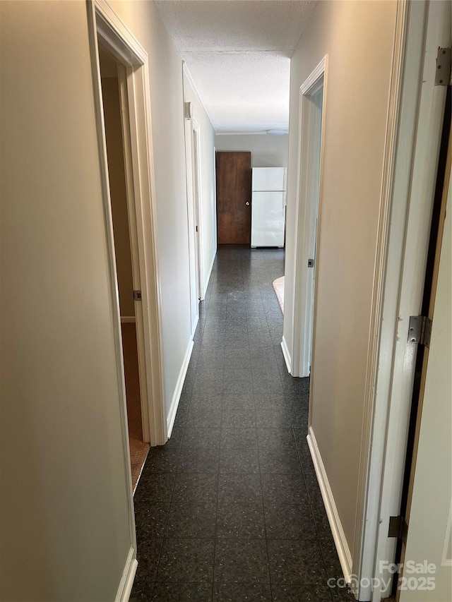 1111 S Skyland Dr, Mount Pleasant, NC 28124 - hallway featuring dark tile patterned floors and baseboards
