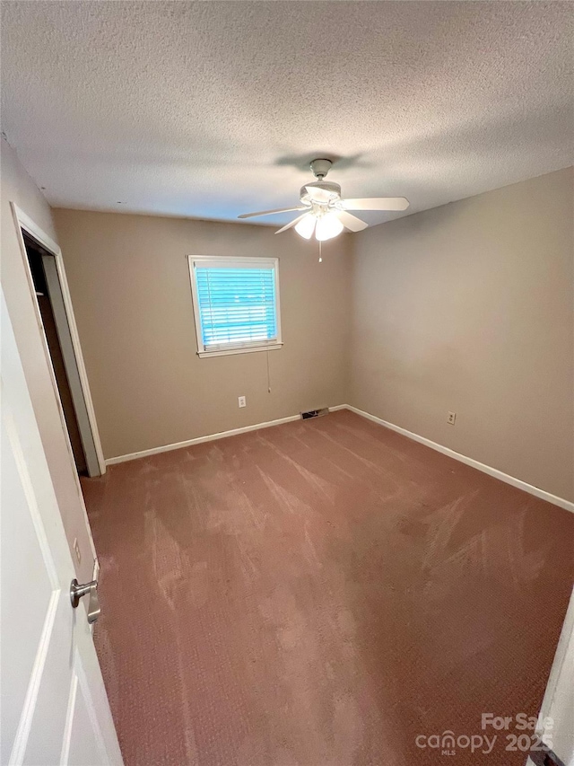 1111 S Skyland Dr, Mount Pleasant, NC 28124 - empty room featuring visible vents, baseboards, ceiling fan, a textured ceiling, and carpet floors