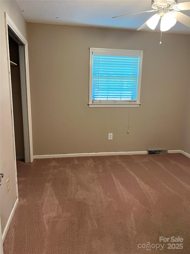 1111 S Skyland Dr, Mount Pleasant, NC 28124 - unfurnished bedroom with ceiling fan, baseboards, visible vents, and carpet floors