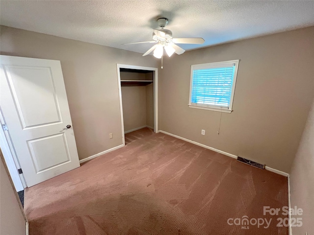 1111 S Skyland Dr, Mount Pleasant, NC 28124 - unfurnished bedroom with visible vents, baseboards, a closet, a textured ceiling, and carpet floors
