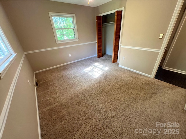 1111 S Skyland Dr, Mount Pleasant, NC 28124 - unfurnished bedroom with a closet, baseboards, and carpet flooring