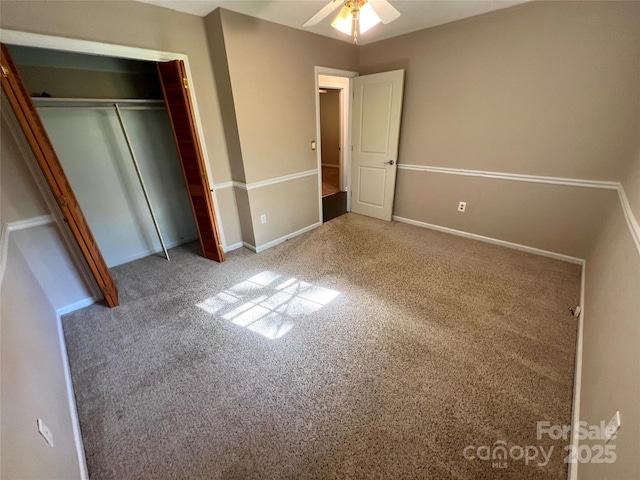 1111 S Skyland Dr, Mount Pleasant, NC 28124 - unfurnished bedroom featuring carpet, a closet, baseboards, and ceiling fan