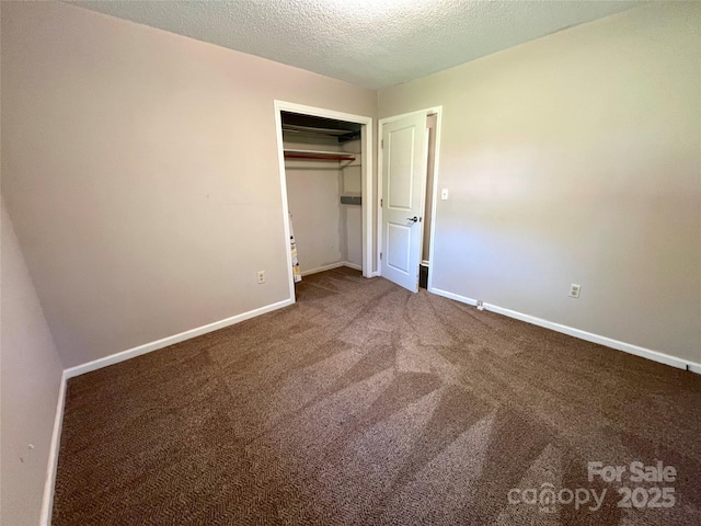 1111 S Skyland Dr, Mount Pleasant, NC 28124 - unfurnished bedroom with carpet floors, baseboards, a closet, and a textured ceiling