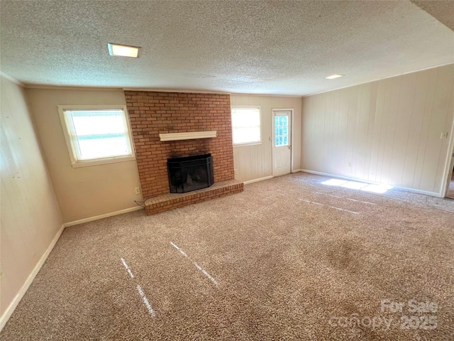 1111 S Skyland Dr, Mount Pleasant, NC 28124 - unfurnished living room featuring baseboards, a textured ceiling, carpet flooring, and a fireplace