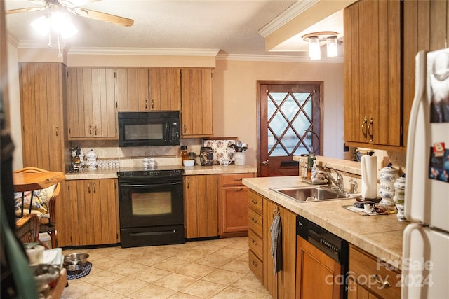 kitchen featuring black appliances, tasteful backsplash, light tile patterned flooring, crown molding, and sink