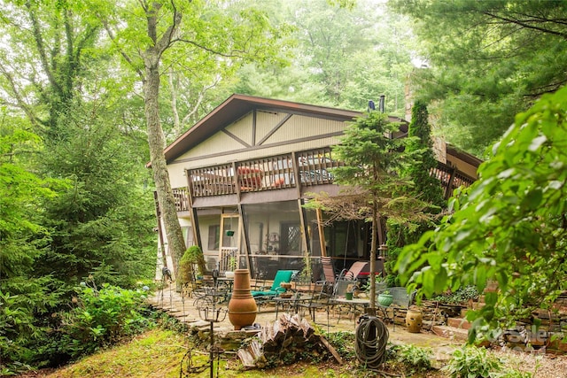 back of property featuring a patio area and a sunroom