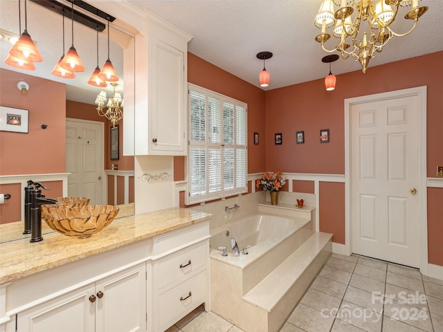 bathroom with a tub, tile patterned flooring, a chandelier, a textured ceiling, and vanity