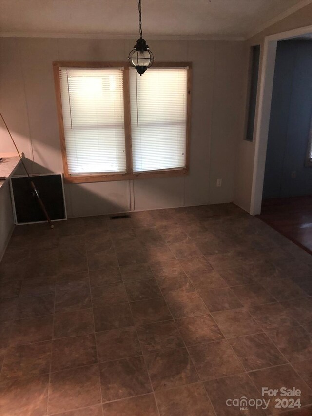 unfurnished dining area with dark tile patterned floors