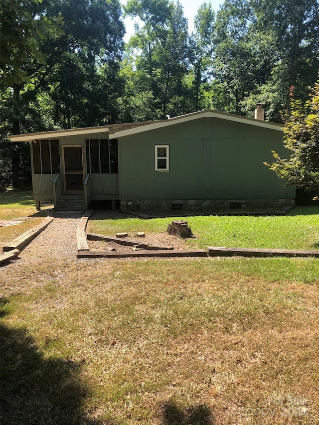 rear view of property featuring a yard