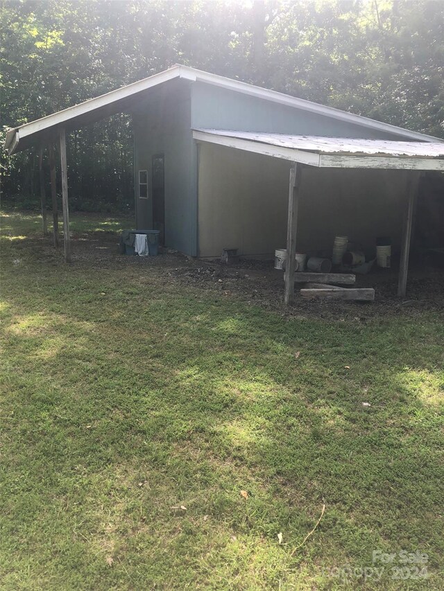 view of outbuilding with a yard