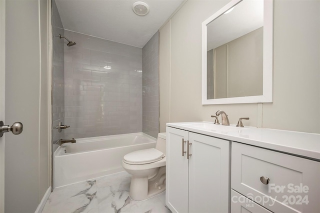 full bathroom featuring tiled shower / bath combo, vanity, and toilet