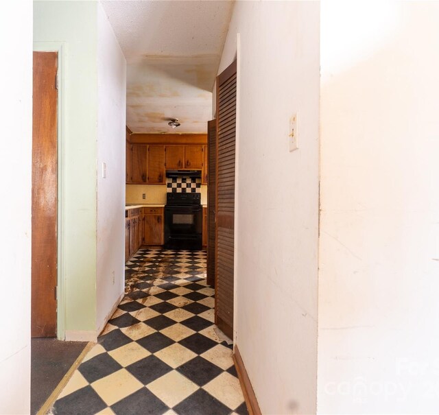 corridor with dark tile patterned flooring